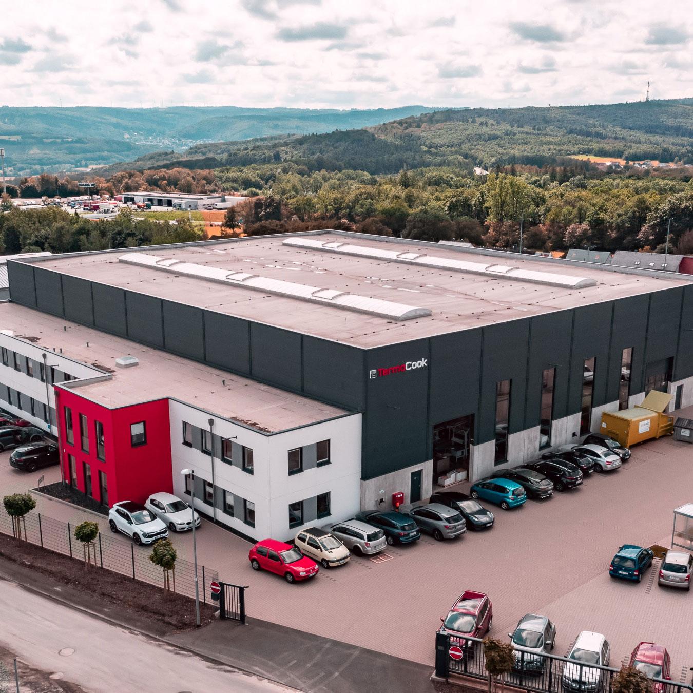Es handelt sich um eine Aufnahme aus der Luft, auf der ein großes Industriegebäude von TermaCook zu sehen ist.